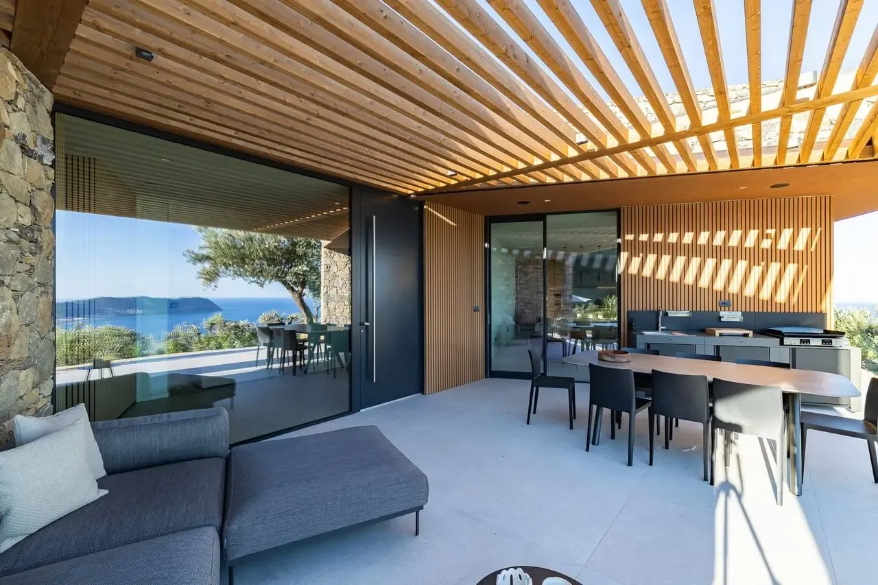 Glass facade of the living room opening onto the covered patio