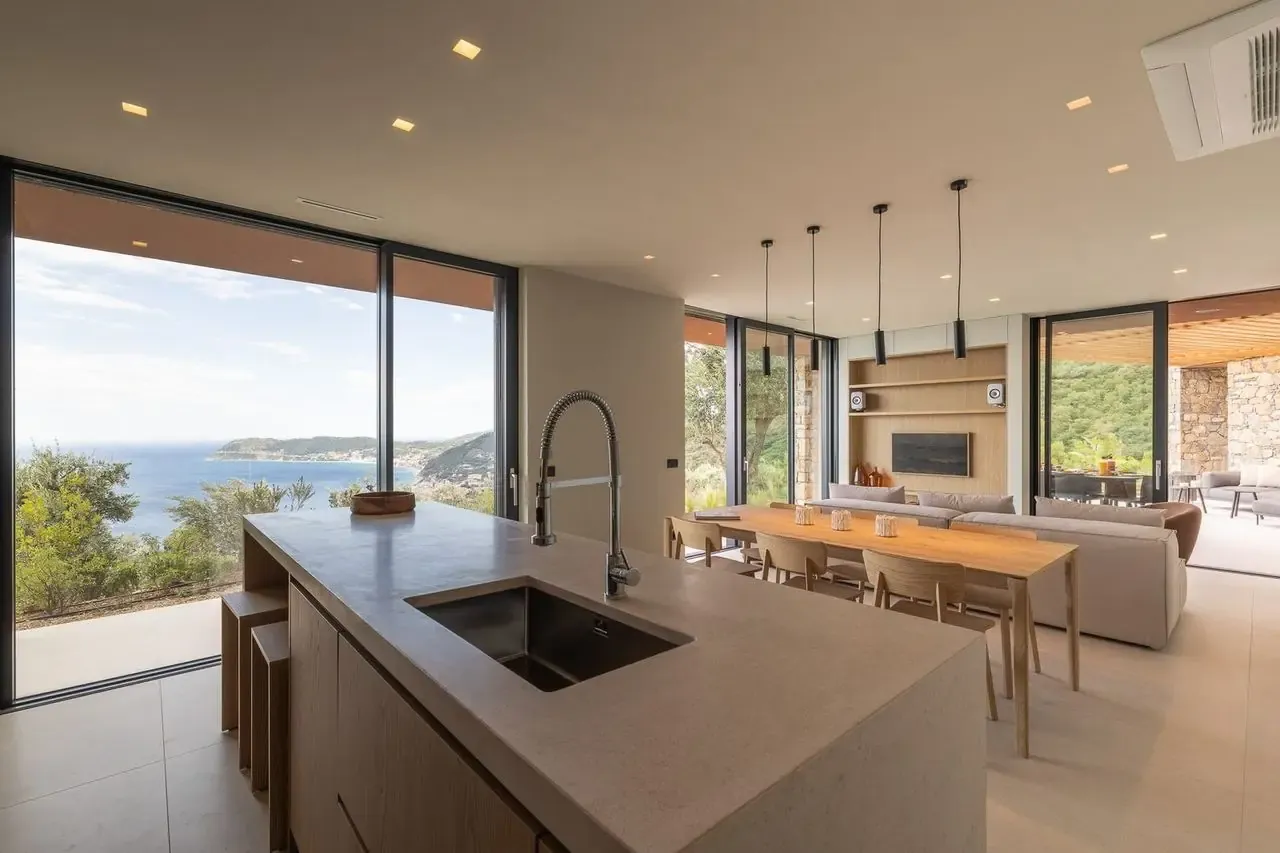 Kitchen island in front of a floor-to-ceiling window looking over the bay